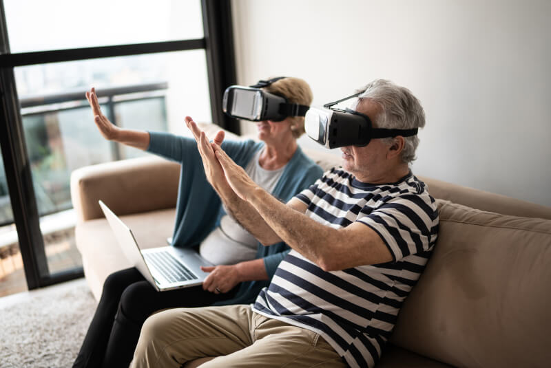 Two people wearing VR headsets accessing the metaverse.