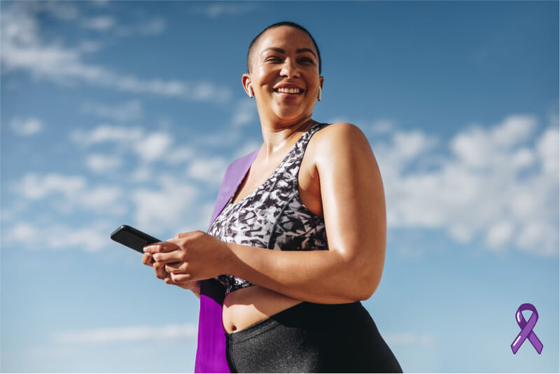 Woman wearing workout clothes holding a cellphone. A Purple ribbon shows a connection to World IBD Day.