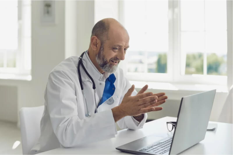 Physician consulting with a diabetes patient over video chat on his laptop.
