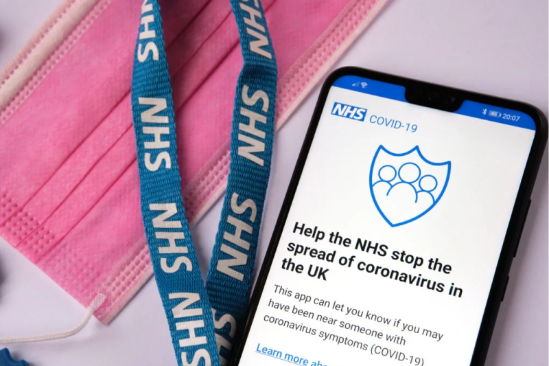 a smartphone screen displaying the text help the NHS stop the spread of coronavirus 